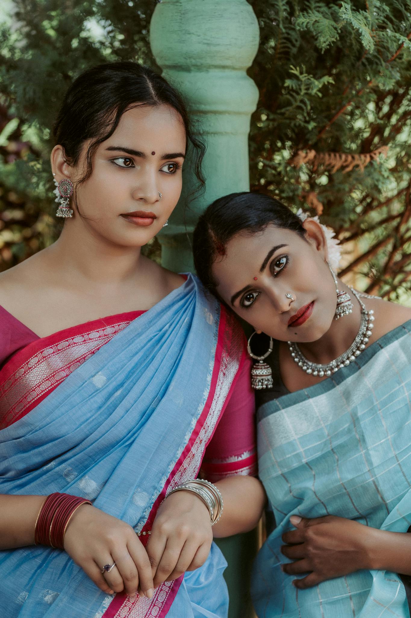 A beautiful portrait capturing two women in vibrant traditional Sri Lankan sarees, showcasing cultural elegance.