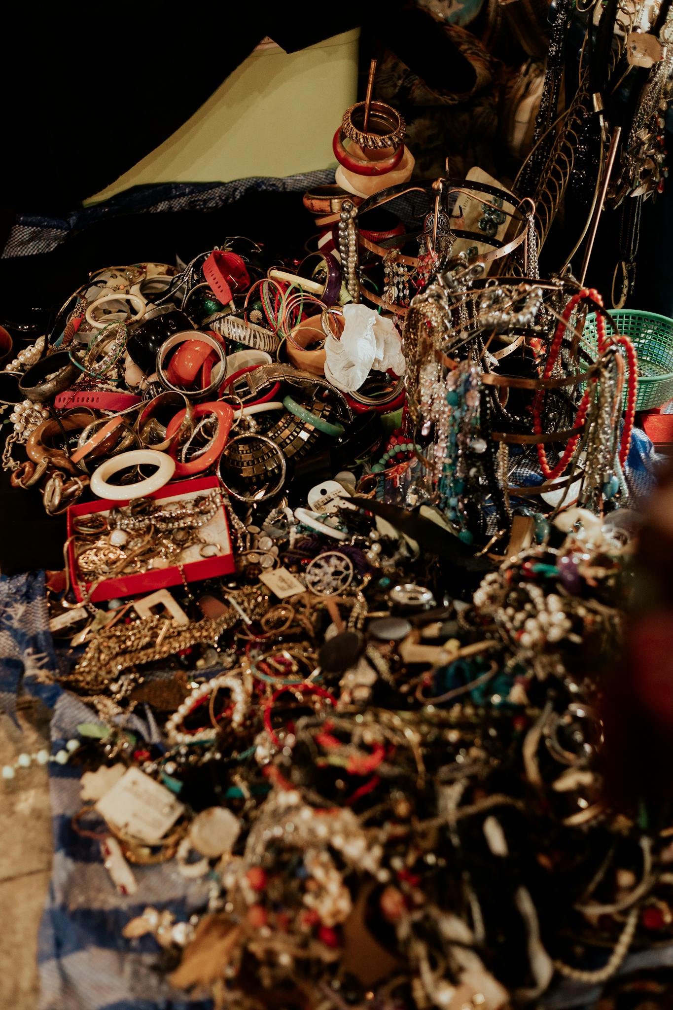 A close-up view of an array of vibrant jewelry pieces at a flea market. Ideal for vintage and fashion concepts.